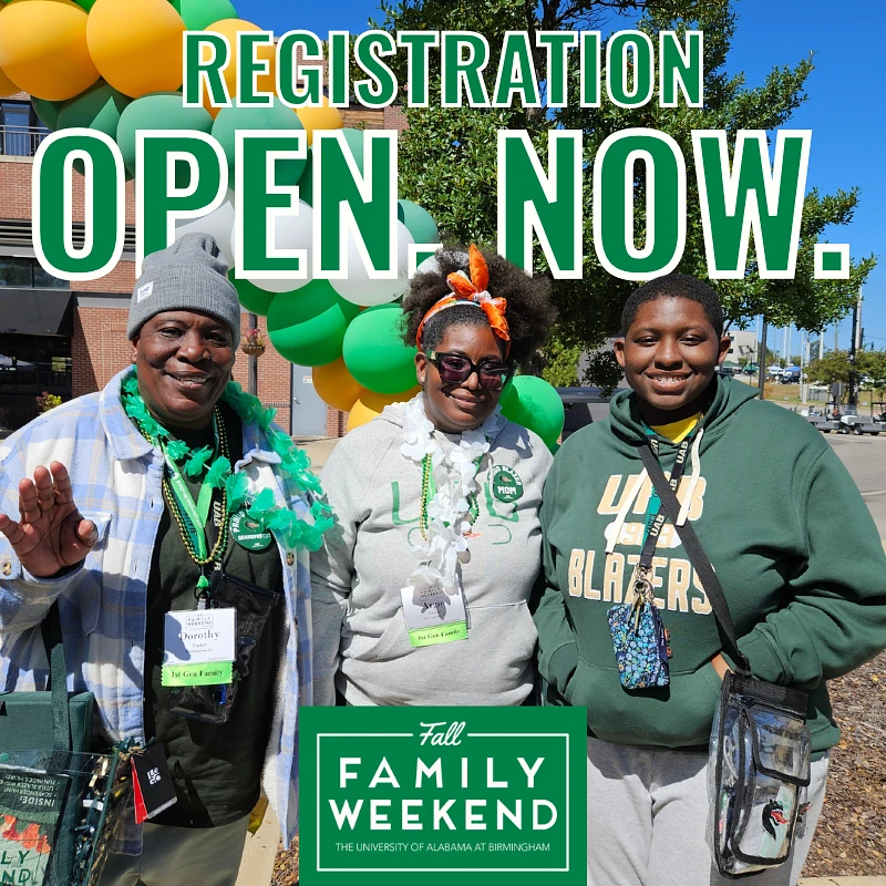 A smiling group poses in front of green and yellow balloons with the text "Registration Open Now" for the University of Alabama at Birmingham's Fall Family Weekend.