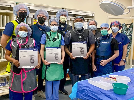 Physicians posing with EMBOLD Fibered Detachable Coil System 